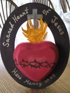 a wooden plaque with a heart and crown on it that says, good heart of jesus have mercy on us