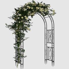 an iron arch with white flowers on it