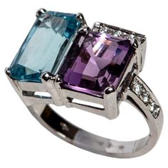 More Details: 7,30g 18kt White Gold 9 White Diamonds VVS-G 0.16ct Topaz and Amethyst total Carat 8.56ct Sizes Amethyst 9,80 x 8,76 x 6,95mm Topaz 12,7 x 7,2 x 5,7mm Blue Topaz, Purple Amethyst and White Diamonds, what an incredible mix of colours that all come together harmoniously in this very special cocktail ring. Handmade in our 150 year old workshop, this elegant ring was inspired by Art Deco shapes but the bright colours have La Dolce Vita Italian way of life running through it. It was an Old Workshop, Triangle Diamond Ring, Art Deco Shapes, Diamond Fashion Rings, Sparkly Things, Modern Ring, Three Stone Engagement Rings, Diamond Rings Bands, Elegant Ring