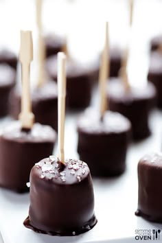 chocolate covered candies with toothpicks sticking out of them