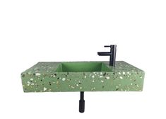 a green sink sitting on top of a black stand