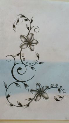 a drawing of flowers and swirls on a piece of paper