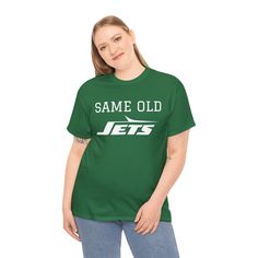 Elevate your sports-inspired wardrobe with our Unisex New York Jets -themed Heavy Cotton Tee – the essential foundation for any fan's collection. This versatile tee goes beyond casual wear, make a statement but also celebrate your passion for the Jets and the excitement of the game. Engineered for optimal comfort, this tee boasts a classic fit and is crafted from medium fabric (5.3 oz/yd²) made of 100% sustainable and highly durable cotton. Say goodbye to itchy interruptions under the arms – the Team Spirit Streetwear T-shirt, Pre-shrunk Team Spirit T-shirt For Streetwear, Team Spirit Streetwear Pre-shrunk T-shirt, Casual Crew Neck T-shirt For Football Season, Sports Fan Tops With Team Name For Streetwear, Sports Season Team T-shirt Fan Apparel, Football Season Team Name Streetwear T-shirt, Sports Season Fan Apparel T-shirt With Logo, Team-colored Tops With Team Name For Streetwear