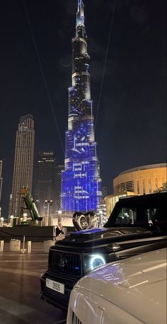 the burj building is lit up in blue and white for the new year's eve celebration