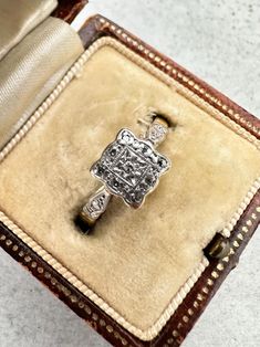 This is a beautiful 1920s 18ct Gold & Platinum Diamond Square Cluster Ring. This gorgeous ring is a stunning vintage piece from the 1920s. A sparkling diamond is set in the centre of the platinum setting, while 8 further sparkling diamond accents are set around the edge of the square face of the ring. The diamonds have been tested and confirmed as natural Ring size P Face of the ring measures 7mm x 7mm approximately. Marked 18ct and PLAT for 18ct Gold and Platinum but partially rubbed. Please no Antique Brilliant Cut Diamond White Diamond Ring, Antique Diamond White Diamond Ring With Brilliant Cut, Vintage Single Cut Diamond Ring For Formal Events, Vintage Single Cut Diamond Ring For Formal Occasions, Antique Diamond White Diamond Ring, Vintage White Gold Diamond Cut Ring, Victorian Diamond White Brilliant Cut Diamond Ring, Vintage Diamond White Diamond Ring For Formal Occasions, Art Deco Platinum Cluster Ring With Diamond Accents