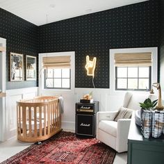 a baby's room with black and white polka dot walls