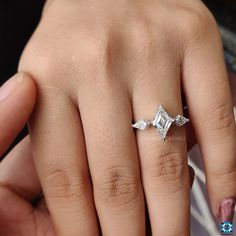 a woman's hand with a diamond ring on her finger and an engagement band