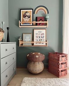 a room with some shelves and pictures on the wall