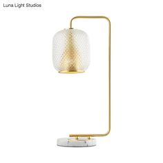 the luna light studio table lamp is shown in gold and white with a marble base