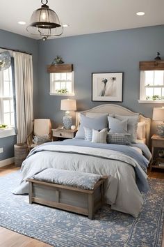 a bedroom with blue walls and white furniture