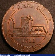 an old british penny with the image of a windmill on it's back side