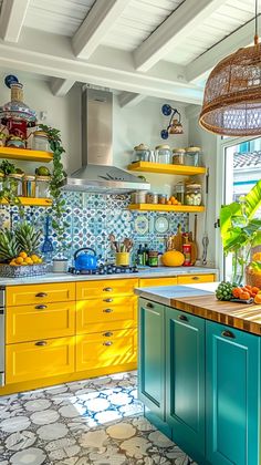 a kitchen with yellow and blue cabinets, green counter tops and an island in the middle