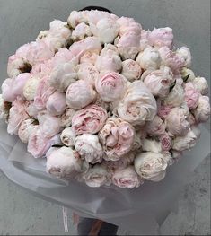 a bouquet of pink and white flowers sitting on top of a table