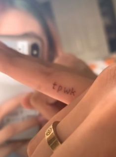 a woman pointing at her finger with the word i love you written on it in cursive writing