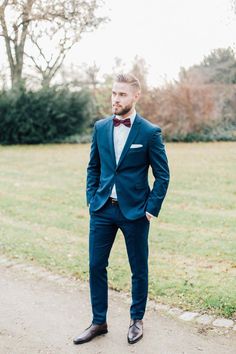 a man in a blue suit and bow tie