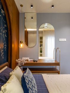 a bedroom with a bed, mirror and sink in the corner on the wall next to it