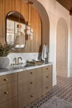 a bathroom with two sinks and a large mirror on the wall above it's counter