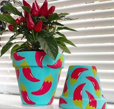 a potted plant sitting on top of a window sill next to two vases