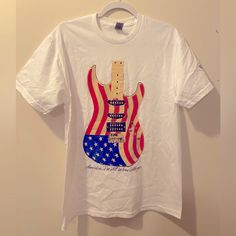 Clint Black Concert T-Shirt Tee T Fall 23 Unisex White Tee American Flag Guitar. Very Good Quality And Soft Tee. It Is Believed It Runs Slightly Oversized And May Also Fit A Large. Great Shirt! Rock And Roll Cotton T-shirt With Graphic Print, Summer Rock T-shirt With Band Logo, Casual Cotton T-shirt For Concert, Rock And Roll T-shirt With Band Logo For Summer, Rock Style Crew Neck T-shirt For Streetwear, White T-shirt For Music Festivals Streetwear, Relaxed Fit T-shirt For Music Festivals Fan Merchandise, Summer Rock Style T-shirt For Streetwear, Rock And Roll Cotton T-shirt With Band Logo