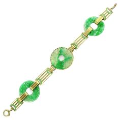 This Art Deco bracelet features three artfully carved jade pi discs connected by geometric links in lime green and white enamel joined by ribbed 14 karat gold links. Signed Wordley, Allsopp & Bliss. Measurements: 7.5” long by 1 1/8” wide Condition notes: The ring that connects to the spring ring for closure has been attached with solder and is not gold. Verde Lime, Bracelet Art, Verde Lima, Art Deco Bracelet, Carved Jade, Jade Carving, White Enamel, Green And White, Spring Rings