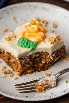 a piece of carrot cake on a plate with a fork