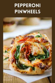 a pizza with spinach and cheese on it sitting on top of a white plate