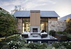 an outdoor living area with furniture and flowers