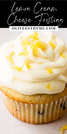 a cupcake with white frosting and yellow sprinkles