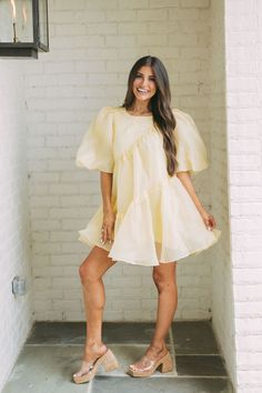 This timeless yellow dress is crafted from a high-quality organza fabric, offering a luxe feel. The dress features puff sleeves and is lined for a comfortable and flattering fit. Make a statement in this elegant and chic style.  100% Polyester  Size Rec: 4-6:S, 8:M, 10-12:L  size down if between sizes  Model is 5'6" with a 35" bust, 26" waist, and 36" hips wearing a size small. Organza Fabric, Puffed Sleeves Dress, Yellow Dress, Trending Now, Puff Sleeves, Puff Sleeve, Chic Style, The Dress, Yellow