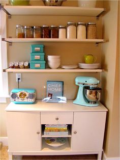 a kitchen shelf filled with lots of food and cooking utensils on top of it