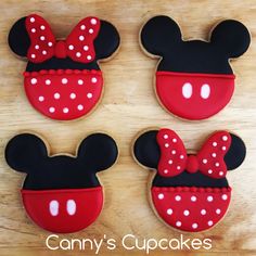 three decorated cookies in the shape of mickey mouse ears