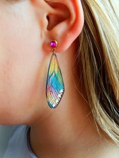 Unique rainbow dragonfly wings earrings dangle, 21st birthday gifts for girls, Boho Fairytale wedding jewelry, Magic Butterflies huggies. Dive into a world where enchantment meets style with our exquisite collection of jewelry that is perfect for any occasion. Whether you're searching for the ideal 21st birthday gift for a special girl, or looking to add a touch of boho fairytale charm to your wedding ensemble, these pieces are designed to captivate and inspire. Unique Rainbow Dragonfly Wings Ea 21st Birthday Gifts For Girls, Magic Butterflies, Jewelry Magic, Wings Earrings, Flower Resin Jewelry, Resin Products, Dragonfly Wings, Dragonfly Jewelry, 21st Birthday Gifts