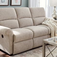 a living room scene with focus on the reclining sofa