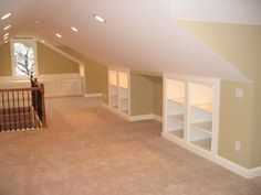 an empty room with no one in it, and shelves on the far wall to the right