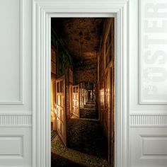 an open door leading to a hallway with lights on the walls and doors in the floor