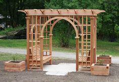 a wooden garden arbor with steps and planters