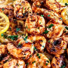 grilled shrimp with lemon wedges and parsley