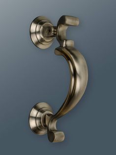 an antique brass door handle on a gray background