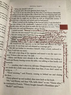 an open book with writing on it and a red marker in the bottom right corner