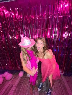 two girls in pink dresses and hats posing for the camera