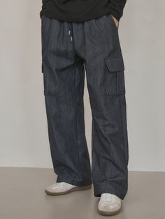 Editor's notesIt is a casual denim pant in non-fade denim fabric that has texture and mood of raw denim but does not bleed. The elastic band on the waist and cargo flap pockets on each side make comfy fit and trendy design. The pant is finished without a washing process so that it does not have any harmful residue on the surface.- Relaxed straight fit- Patch flap pockets- Side pockets- Back pocketMeasurements(in.)M / L- Length: 40.6 in. / 41.1 in.- Waist: 12 in. / 12.8 in.- Hip: 19.3 in. / 20.5 in.- Thigh: 11.8 in. / 12.6 in.- Hem: 9.4 in. / 10 in.- Rise: 13.8 in. / 14.4 in.*Model info: Height 6’ 2” / Fitting size: Size LComposition & Care- 65% Cotton, 35% Polyester- Dry clean recommended- Wash in cold water- Avoid tumble dryDesigner- by WEDNESDAY OASIS Casual Washed Blue Cargo Pants With Patch Pockets, Casual Washed Blue Cargo Jeans With Hip Pockets, Casual Washed Blue Cargo Jeans, Baggy Indigo Jeans With Pockets, Dark Wash Rigid Denim Cargo Jeans, Casual Rigid Denim Cargo Jeans With Pockets, Casual Washed Blue Cargo Pants, Indigo Rigid Denim Pants With Pockets, Casual Wide Leg Rigid Denim Cargo Pants