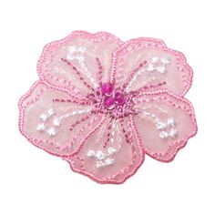 a pink flower with white flowers on it's center and some beads in the middle