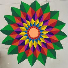 a colorful flower made out of paper on the floor