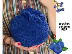 a woman is holding a blue beanie bag with berries on it and the text crochet pattern pdf