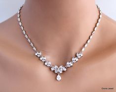 "bridal rhinestone necklace, bridal crystal necklace, wedding rhinestone necklace, bridal necklace, wedding necklace, statement necklace This statement necklace is made with cubic zirconia stones.  Crystals shape are marquise, teardrops, and round. It has rhodium finish chain to complete the rest of the length. Focal measures about 10 3/4\" long by 1 7/8\" in the middle including the teardrop.  Has the right amount of sparkle for your vintage inspired wedding or special occasion event.  This necklace can be made without the chain upon request.  Contact me happy to give you a quote. Perfect for a classy bride or any special occasion! ." Dazzling Rhinestone Wedding Necklaces, Glamorous Diamond White Rhinestone Necklace For Weddings, Crystal Bling Backdrop Necklace For Wedding, Diamond Bling Necklace For Wedding, Wedding Cubic Zirconia Rhinestone Necklace, Diamond Necklace With Bling For Wedding, Wedding Diamond Necklace With Bling, Sparkling White Rhinestone Necklace For Wedding, Wedding Rhinestone Diamond White Necklace