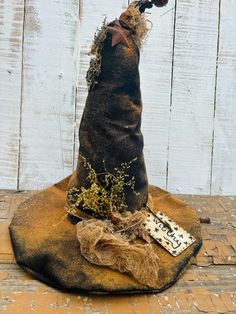 a wizard's hat is sitting on top of a piece of cloth and some twigs