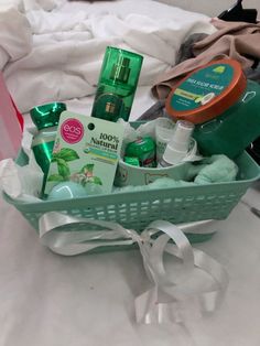 a basket filled with personal care items on top of a white bed covered in sheets