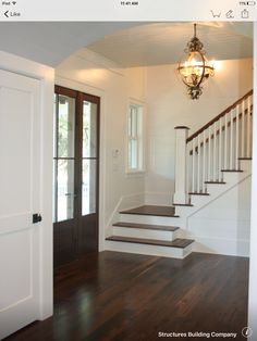 an empty entryway with stairs leading up to the second floor