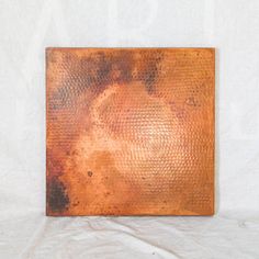 an old rusty metal plate on a white background with some rusted paint in the middle