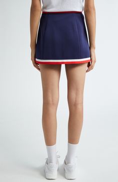 Sporty stripes highlight the waist of this preppy skirt boasting logo branding and comfortable stretch. Pull-on style 95% polyester, 5% spandex Dry clean or machine wash, line dry Imported Asian & Pacific Islander Owned/Founded Sporty Elastane Skort With Lined Skirt, Navy Fitted Sporty Skort, Sporty Fitted Navy Skort, Sporty Elastane Skort, Sporty Elastane Mini Tennis Skirt, Sporty Mini Tennis Skirt In Elastane, Sporty Mini Skort In Elastane, Sporty Elastane Mini Skort, Sporty Short Elastane Skirt